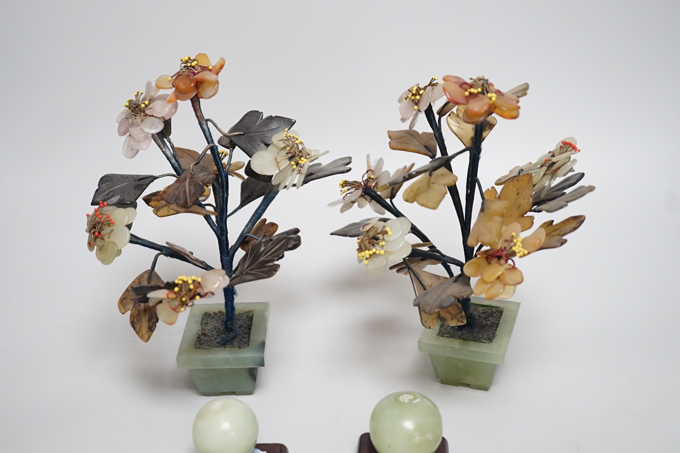 A pair of Chinese hardstone model trees and two model fruits, trees 21cms high